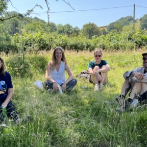 The team sat in a field