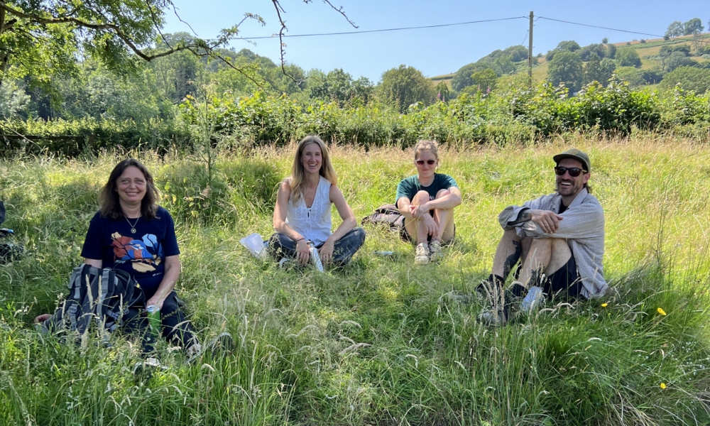 The team sat in a field